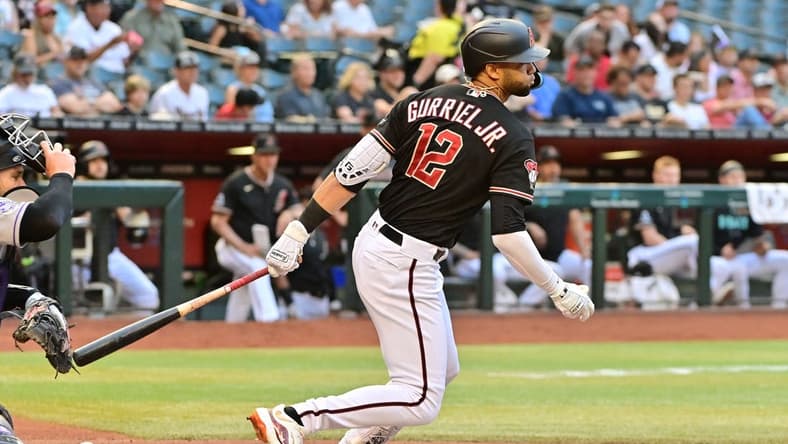 May 31, 2023; Phoenix, Arizona, USA; Arizona Diamondbacks left fielder Lourdes Gurriel Jr. (12) hits a two RBI single in the first inning against the Colorado Rockies at Chase Field. Mandatory Credit: Matt Kartozian-USA TODAY Sports