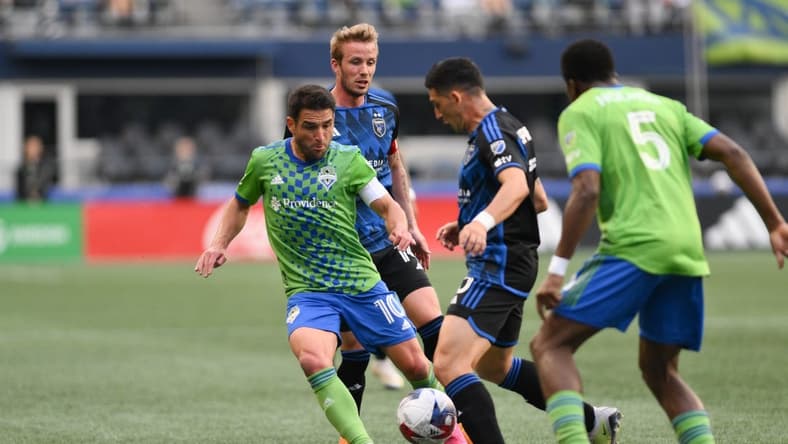 May 31, 2023; Seattle, Washington, USA; Seattle Sounders midfielder Nicolas Lodeiro (10) and San Jose Earthquakes forward Cristian Espinoza (10) fight for the ball during the first half at Lumen Field. Mandatory Credit: Steven Bisig-USA TODAY Sports