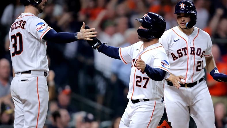 Jun 1, 2023; Houston, Texas, USA; Houston Astros second baseman Jose Altuve (27) is greeted by Houston Astros right fielder Kyle Tucker (30) after scoring a run against the Los Angeles Angels during the fifth inning at Minute Maid Park. Mandatory Credit: Erik Williams-USA TODAY Sports
