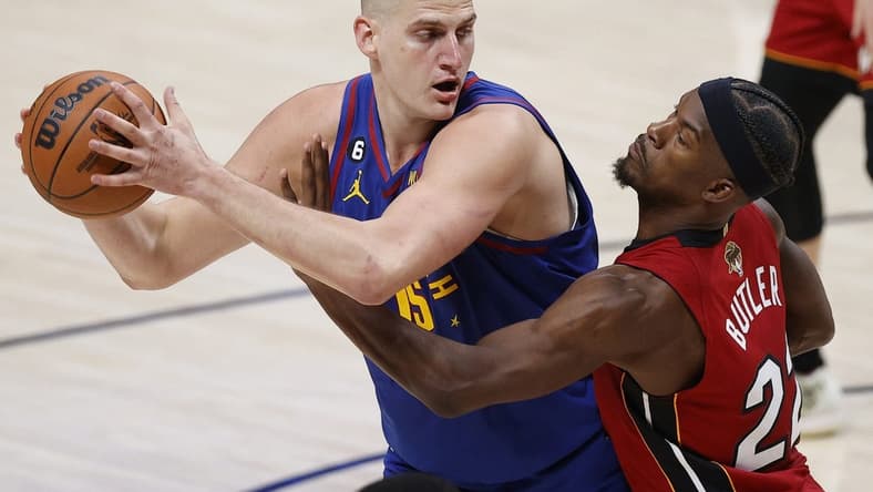 Jun 1, 2023; Denver, CO, USA; Denver Nuggets center Nikola Jokic (15) controls the ball while defended by Miami Heat forward Jimmy Butler (22) during the second quarter in game one of the 2023 NBA Finals at Ball Arena. Mandatory Credit: Isaiah J. Downing-USA TODAY Sports
