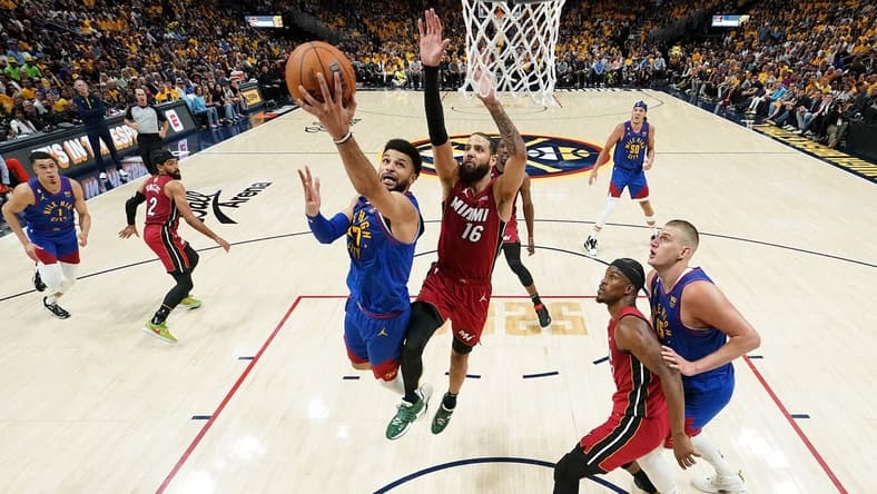 Jun 1, 2023; Denver, CO, USA; Denver Nuggets guard Jamal Murray (27) shoots the ball against Miami Heat forward Caleb Martin (16) during the first half in game one of the 2023 NBA Finals at Ball Arena. Mandatory Credit: Kyle Terada-USA TODAY Sports