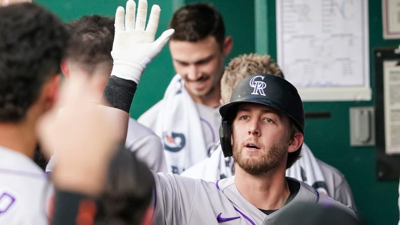 Jun 2, 2023; Kansas City, Missouri, USA; Colorado Rockies third baseman Ryan McMahon (24) is congratulated in the dugout against the Kansas City Royals after his solo home run in the first inning at Kauffman Stadium. Mandatory Credit: Denny Medley-USA TODAY Sports