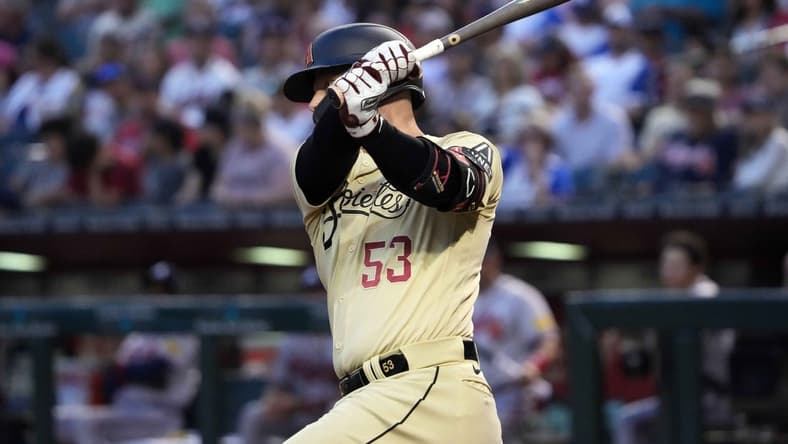 Jun 2, 2023; Phoenix, Arizona, USA; Arizona Diamondbacks first baseman Christian Walker (53) hits an RBI double against the Atlanta Braves during the third inning at Chase Field. Mandatory Credit: Joe Camporeale-USA TODAY Sports