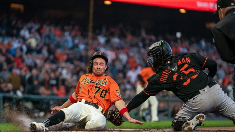 Jun 2, 2023; San Francisco, California, USA;  San Francisco Giants center fielder Brett Wisely (70) is tagged out by Baltimore Orioles catcher Adley Rutschman (35) during the third inning at Oracle Park. Mandatory Credit: Neville E. Guard-USA TODAY Sports