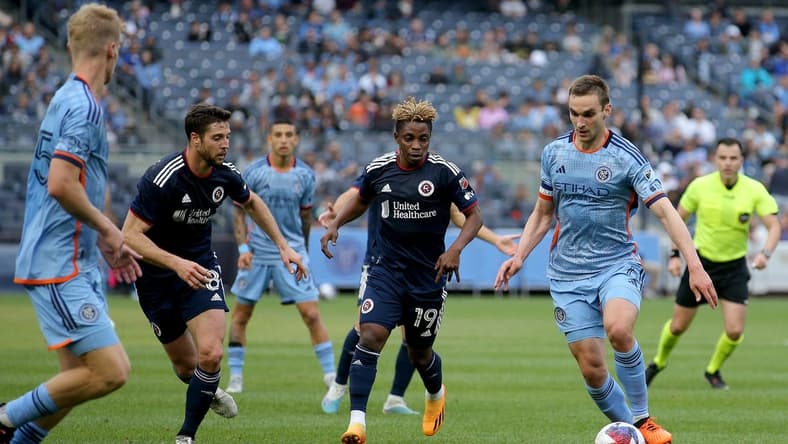 Jun 3, 2023; New York, New York, USA; New York City FC midfielder James Sands (6) brings the ball up the pitch against New England Revolution forward Latif Blessing (19) and midfielder Matt Polster (8) during the first half at Yankee Stadium. Mandatory Credit: Brad Penner-USA TODAY Sports