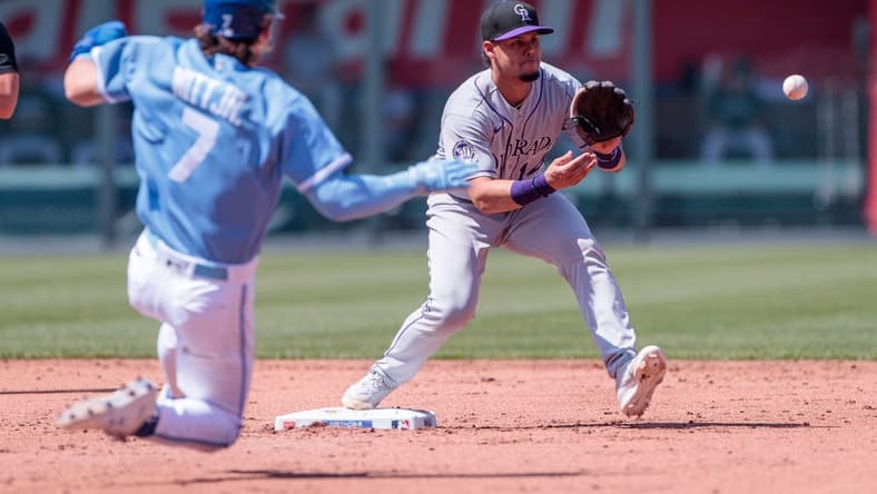 Jun 3, 2023; Kansas City, Missouri, USA; Colorado Rockies shortstop Ezequiel Tovar (14) reaches for a throw ahead of Kansas City Royals shortstop Bobby Witt Jr. (7) sliding into second base during the first inning at Kauffman Stadium. Mandatory Credit: William Purnell-USA TODAY Sports