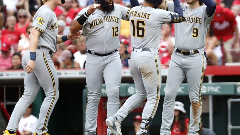 Jun 3, 2023; Cincinnati, Ohio, USA; Milwaukee Brewers right fielder Blake Perkins (16) reacts with center fielder Joey Wiemer (28), first baseman Jon Singleton (12), and  third baseman Brian Anderson (9) after hitting a grand slam against the Cincinnati Reds during the third inning at Great American Ball Park. Mandatory Credit: David Kohl-USA TODAY Sports
