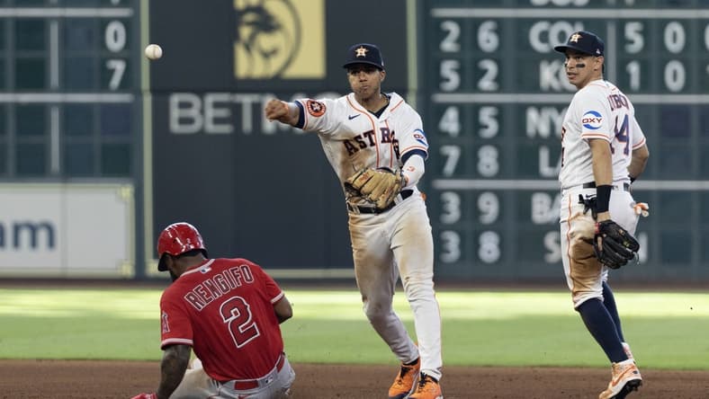 Jun 3, 2023; Houston, Texas, USA; Los Angeles Angels third baseman Luis Rengifo (2) is forced out at second base by Houston Astros shortstop Jeremy Pena (3) while second baseman Mauricio Dubon (14) looks on in the fifth inning at Minute Maid Park. Mandatory Credit: Thomas Shea-USA TODAY Sports