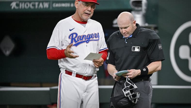 Jun 3, 2023; Arlington, Texas, USA; Texas Rangers manager Bruce Bochy (15) talks with home plate umpire Mike Estabrook during the game against the Seattle Mariners at Globe Life Field. Mandatory Credit: Jerome Miron-USA TODAY Sports