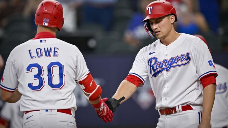 Jun 3, 2023; Arlington, Texas, USA; Texas Rangers first baseman Nathaniel Lowe (30) and shortstop Corey Seager (5) celebrate after Lowe hits a two run home run during the seventh inning against the Seattle Mariners at Globe Life Field. Mandatory Credit: Jerome Miron-USA TODAY Sports