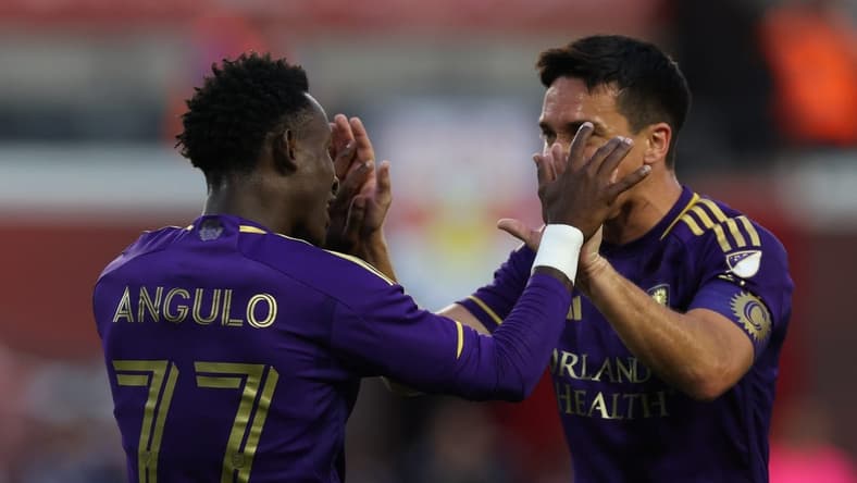 Jun 3, 2023; Harrison, New Jersey, USA; Orlando City forward Ivan Angulo (77) celebrates with Orlando City midfielder Mauricio Pereyra (10) after scoring a goal during the first half at Red Bull Arena. Mandatory Credit: Vincent Carchietta-USA TODAY Sports