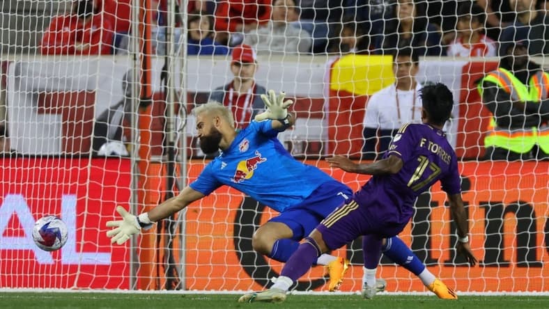 Jun 3, 2023; Harrison, New Jersey, USA;  Orlando City forward Facundo Torres (17) scores a goal past New York Red Bulls goalkeeper Carlos Miguel Coronel (1) in the second half at Red Bull Arena. Mandatory Credit: Vincent Carchietta-USA TODAY Sports