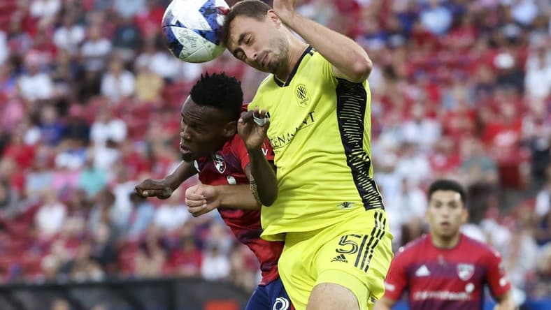Jun 3, 2023; Frisco, Texas, USA;  Nashville SC defender Jack Maher (5) heads the ball away from FC Dallas forward Jader Obrian (8) during the first half at Toyota Stadium. Mandatory Credit: Kevin Jairaj-USA TODAY Sports