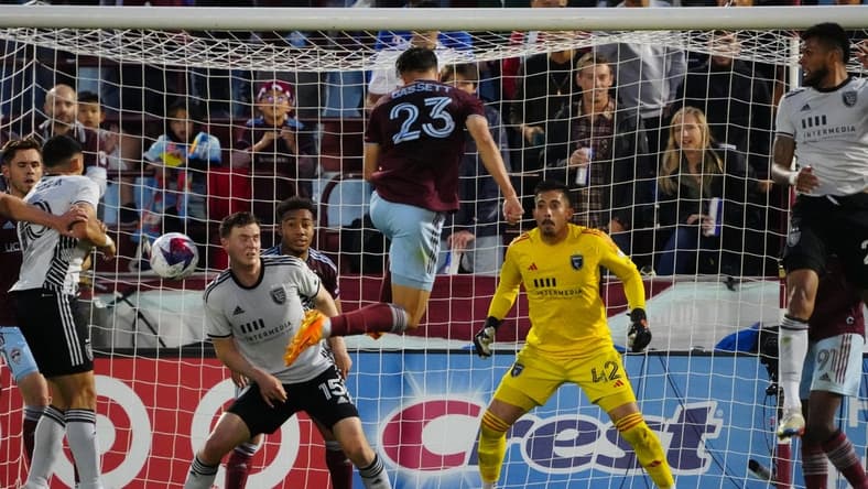 Jun 3, 2023; Commerce City, Colorado, USA; Colorado Rapids midfielder Cole Bassett (23) heads the ball against San Jose Earthquakes defender Tanner Beason (15) as San Jose Earthquakes goalkeeper Daniel (42) defends the goal during the first half at Dick's Sporting Goods Park. Mandatory Credit: Ron Chenoy-USA TODAY Sports