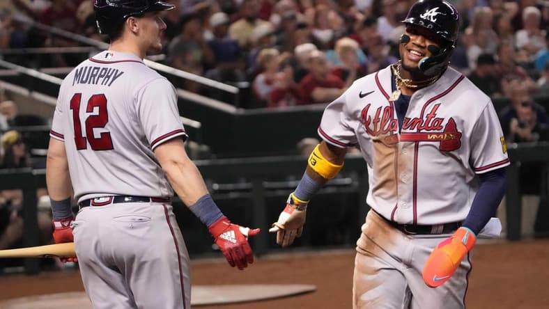 Jun 3, 2023; Phoenix, Arizona, USA; Atlanta Braves right fielder Ronald Acuna Jr. (13) slaps hands with Atlanta Braves catcher Sean Murphy (12) after scoring a run against the Arizona Diamondbacks during the third inning at Chase Field. Mandatory Credit: Joe Camporeale-USA TODAY Sports