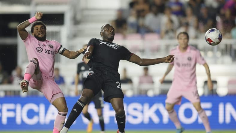 Jun 3, 2023; Fort Lauderdale, Florida, USA; D.C. United forward Christian Benteke (20) shoots the ball against Inter Miami midfielder Dixon Arroyo (2) during the second half at DRV PNK Stadium. Mandatory Credit: Sam Navarro-USA TODAY Sports