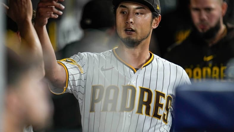 Jun 3, 2023; San Diego, California, USA; San Diego Padres starting pitcher Yu Darvish (11) is greeted by teammates after the seventh inning against the Chicago Cubs at Petco Park. Mandatory Credit: Ray Acevedo-USA TODAY Sports