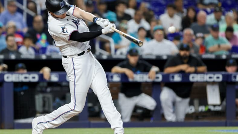 Jun 4, 2023; Miami, Florida, USA; Miami Marlins designated hitter Garrett Cooper (26) hits a three-run home run against the Oakland Athletics during the fifth inning at loanDepot Park. Mandatory Credit: Sam Navarro-USA TODAY Sports