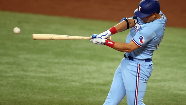 Jun 4, 2023; Arlington, Texas, USA; Texas Rangers first baseman Nathaniel Lowe (30) singles in the third inning against the Seattle Mariners at Globe Life Field. Mandatory Credit: Tim Heitman-USA TODAY Sports