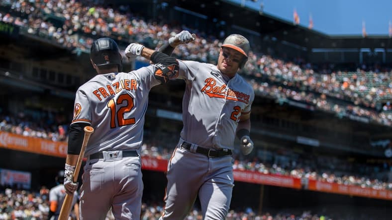 Jun 4, 2023; San Francisco, California, USA; Baltimore Orioles catcher James McCann (27) is congratulated by second baseman Adam Frazier (12) after hitting a solo home run against the San Francisco Giants during the sixth inning at Oracle Park. Mandatory Credit: John Hefti-USA TODAY Sports