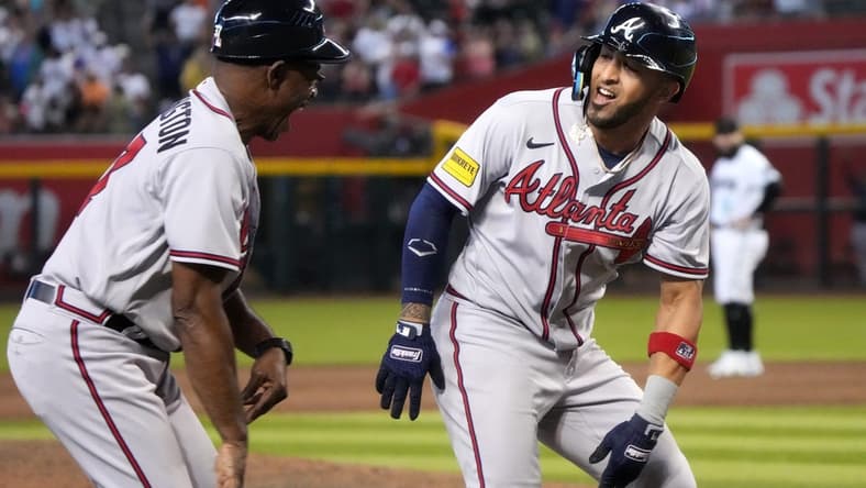 Jun 4, 2023; Phoenix, AZ, USA; Atlanta Braves' Eddie Rosario (8) celebrates his ninth inning grand slam with third base coach Ron Washington (37) against the Arizona Diamondbacks at Chase Field. Mandatory Credit: Joseph Rondone-USA TODAY Sports