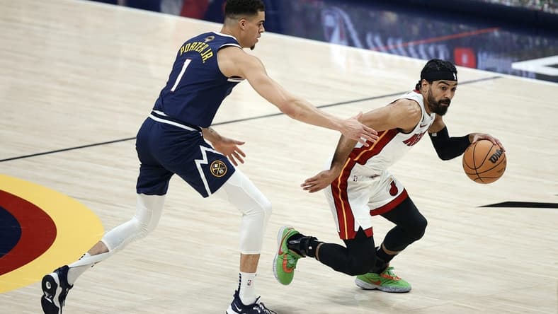 Jun 4, 2023; Denver, CO, USA; Miami Heat guard Gabe Vincent (2) controls the ball against Denver Nuggets forward Michael Porter Jr. (1) in the first half in game two of the 2023 NBA Finals at Ball Arena. Mandatory Credit: Isaiah J. Downing-USA TODAY Sports