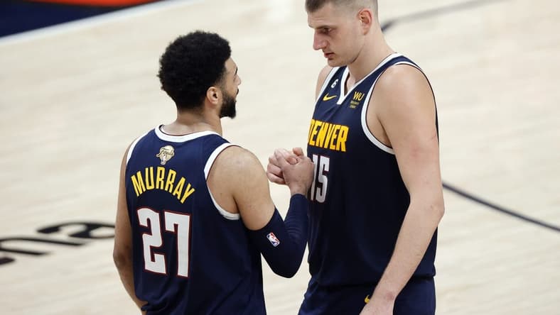 Jun 4, 2023; Denver, CO, USA; Denver Nuggets center Nikola Jokic (15) and guard Jamal Murray (27) react in the second quarter against the Miami Heat in game two of the 2023 NBA Finals at Ball Arena. Mandatory Credit: Isaiah J. Downing-USA TODAY Sports