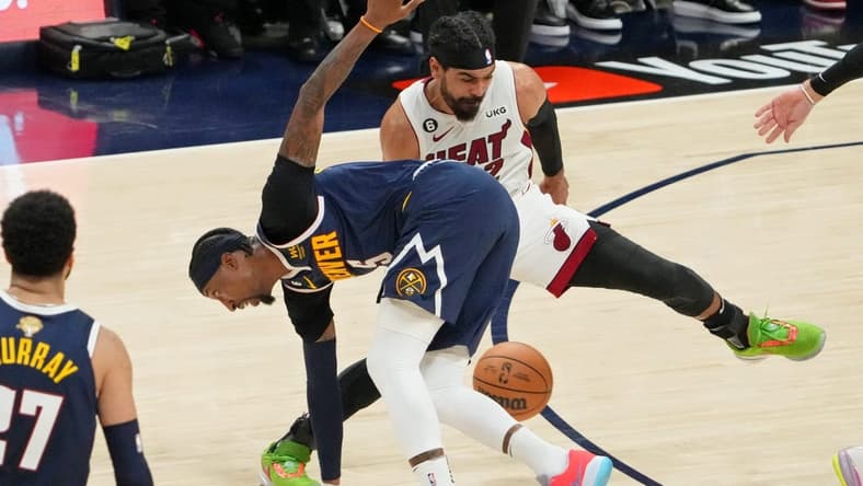 Jun 4, 2023; Denver, CO, USA; Denver Nuggets guard Kentavious Caldwell-Pope (5) battles for the ball against Miami Heat guard Gabe Vincent (2) during the third quarter in game two of the 2023 NBA Finals at Ball Arena. Mandatory Credit: Kyle Terada-USA TODAY Sports