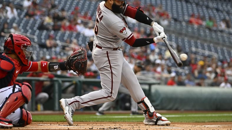 Jun 6, 2023; Washington, District of Columbia, USA; Arizona Diamondbacks designated hitter Emmanuel Rivera (15) hits a RBI single against the Washington Nationals during the first inning at Nationals Park. Mandatory Credit: Brad Mills-USA TODAY Sports