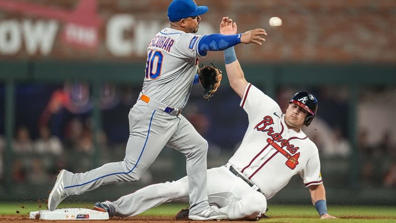 Jun 6, 2023; Cumberland, Georgia, USA; New York Mets third baseman Eduardo Escobar (10) throws for a double play over Atlanta Braves third baseman Austin Riley (27) during the first inning at Truist Park. Mandatory Credit: Dale Zanine-USA TODAY Sports