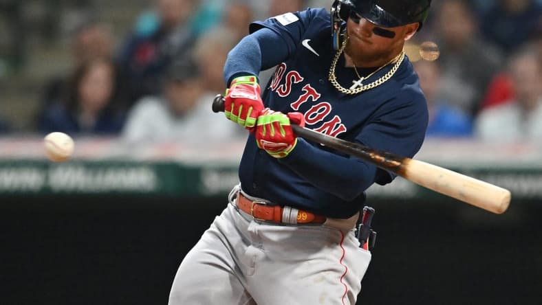 Jun 6, 2023; Cleveland, Ohio, USA; Boston Red Sox right fielder Alex Verdugo (99) hits a sacrifice fly during the eighth inning against the Cleveland Guardians at Progressive Field. Mandatory Credit: Ken Blaze-USA TODAY Sports