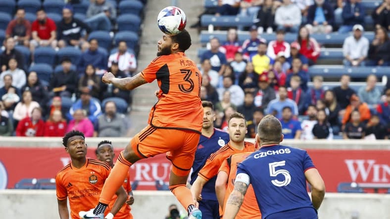 Jun 6, 2023; Bridgeview, IL, USA; Houston Dynamo defender Micael (31) heads the ball against the Chicago Fire during the first half at SeatGeek Stadium. Mandatory Credit: Mike Dinovo-USA TODAY Sports