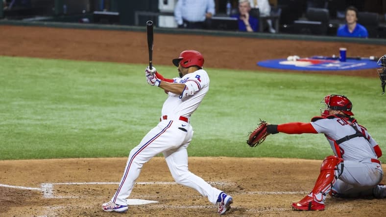 Jun 6, 2023; Arlington, Texas, USA; Texas Rangers second baseman Marcus Semien (2) hits a two-run double during the fourth inning against the St. Louis Cardinals at Globe Life Field. Mandatory Credit: Kevin Jairaj-USA TODAY Sports