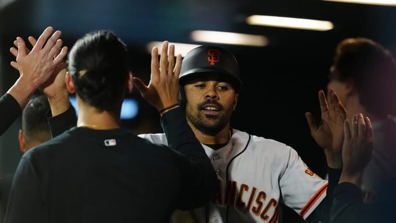 Jun 6, 2023; Denver, Colorado, USA; San Francisco Giants first baseman LaMonte Wade Jr. (31) celebrates scoring a run in the seventh inning against the Colorado Rockies at Coors Field. Mandatory Credit: Ron Chenoy-USA TODAY Sports