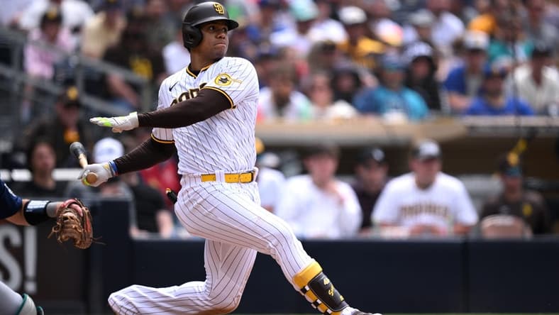Jun 7, 2023; San Diego, California, USA; San Diego Padres left fielder Juan Soto (22) hits a two-RBI single against the Seattle Mariners during the fifth inning at Petco Park. Mandatory Credit: Orlando Ramirez-USA TODAY Sports