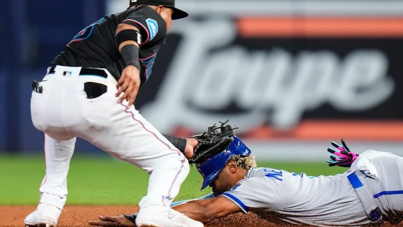 Jun 7, 2023; Miami, Florida, USA; Miami Marlins second baseman Luis Arraez (3) tags out Kansas City Royals right fielder MJ Melendez (1) during the fourth inning at loanDepot Park. Mandatory Credit: Rich Storry-USA TODAY Sports