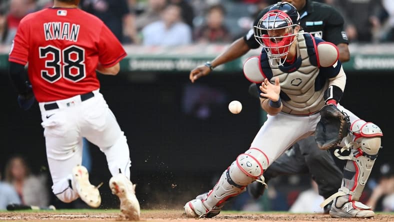 Jun 7, 2023; Cleveland, Ohio, USA; Boston Red Sox catcher Connor Wong (12) waits for the ball as Cleveland Guardians left fielder Steven Kwan (38) scores during the fifth inning at Progressive Field. Mandatory Credit: Ken Blaze-USA TODAY Sports