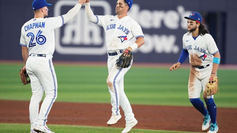 Jun 7, 2023; Toronto, Ontario, CAN; Toronto Blue Jays third baseman Matt Chapman (26) celebrates the win with Toronto Blue Jays second baseman Whit Merrifield (15) against the Houston Astros at the end of the ninth inning at Rogers Centre. Mandatory Credit: Nick Turchiaro-USA TODAY Sports