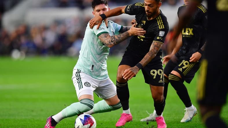 Jun 7, 2023; Los Angeles, California, USA; Los Angeles FC forward Denis Bouanga (99) moves in for the ball against Atlanta United midfielder Franco Ibarra (14) during the first half at BMO Stadium. Mandatory Credit: Gary A. Vasquez-USA TODAY Sports