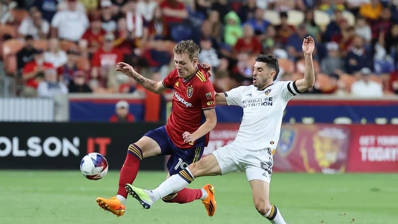 Jun 7, 2023; Sandy, UT, USA; Real Salt Lake midfielder Bode Hidalgo (19) and Los Angeles Galaxy midfielder Gast n Brugman (5) play for a ball in the second half at America First Field. Mandatory Credit: Rob Gray-USA TODAY Sports