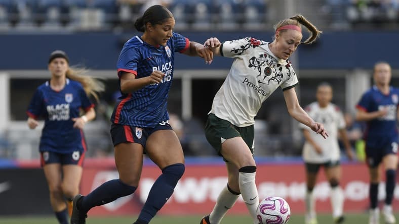 Jun 3, 2023; Seattle, Washington, USA; OL Reign forward Elyse Bennett (34) and Portland Thorns FC defender Becky Sauerbrunn (4) battle for the ball during the second half at Lumen Field. Mandatory Credit: Michael Thomas Shroyer-USA TODAY Sports