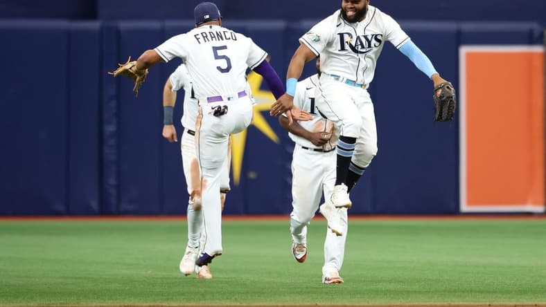 Jun 6, 2023; St. Petersburg, Florida, USA; Tampa Bay Rays center fielder Manuel Margot (13) and shortstop Wander Franco (5) celebrate as they beat the Minnesota Twins at Tropicana Field. Mandatory Credit: Kim Klement-USA TODAY Sports