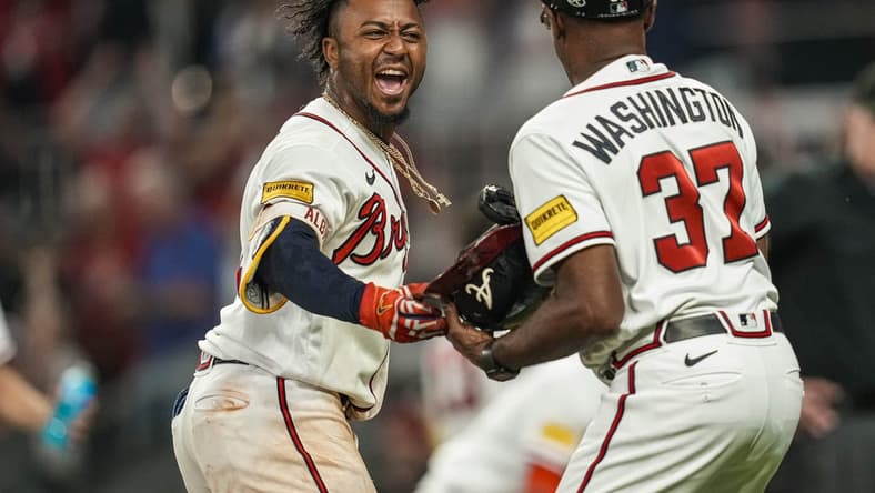 Jun 8, 2023; Cumberland, Georgia, USA; Atlanta Braves second baseman Ozzie Albies (1) reacts by handing his helmet to third base coach Ron Washington (37) after hitting a walk off three run home run against the New York Mets during the tenth inning at Truist Park. Mandatory Credit: Dale Zanine-USA TODAY Sports