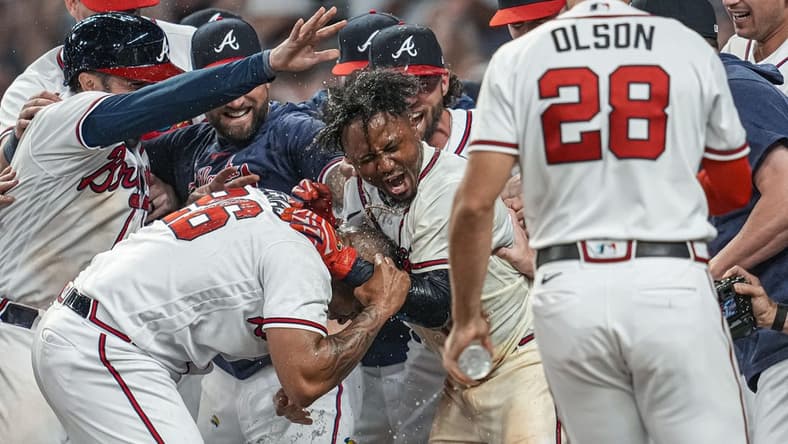 Jun 8, 2023; Cumberland, Georgia, USA; Atlanta Braves players react with second baseman Ozzie Albies (1) after his game winning three run home run against the New York Mets during the tenth inning at Truist Park. Mandatory Credit: Dale Zanine-USA TODAY Sports