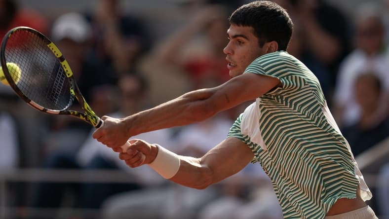 Jun 9 2023; Paris,France; Carlos Alcaraz (ESP) returns a shot during his semifinal match against Novak Djokovic (SRB) on day 13 at Stade Roland-Garros. Mandatory Credit: Susan Mullane-USA TODAY Sports