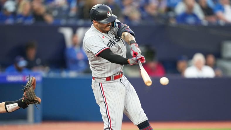 Jun 9, 2023; Toronto, Ontario, CAN; Minnesota Twins shortstop Carlos Correa (4) hits a single against the Toronto Blue Jays during the sixth inning at Rogers Centre. Mandatory Credit: Nick Turchiaro-USA TODAY Sports