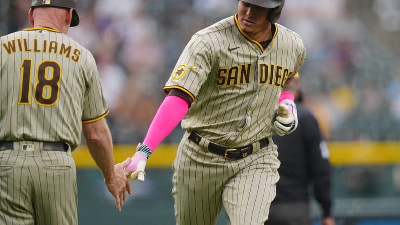 Jun 9, 2023; Denver, Colorado, USA; San Diego Padres third baseman Manny Machado (13) celebrates his two-run home run with San Diego Padres third base coach Matt Williams (18) in the first inning against the Colorado Rockies at Coors Field. Mandatory Credit: Ron Chenoy-USA TODAY Sports