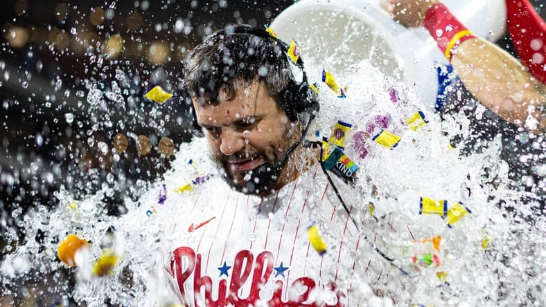 Jun 9, 2023; Philadelphia, Pennsylvania, USA; Philadelphia Phillies left fielder Kyle Schwarber (12) is doused by a cooler of water and bubble gum after hitting a walk off game winning home run against the Los Angeles Dodgers during the ninth inning at Citizens Bank Park. Mandatory Credit: Bill Streicher-USA TODAY Sports