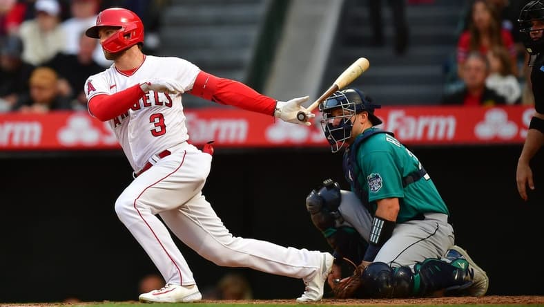 Jun 9, 2023; Anaheim, California, USA; Los Angeles Angels left fielder Taylor Ward (3) reaches first on a fielding error by Seattle Mariners shortstop J.P. Crawford (3) during the third inning at Angel Stadium. Mandatory Credit: Gary A. Vasquez-USA TODAY Sports