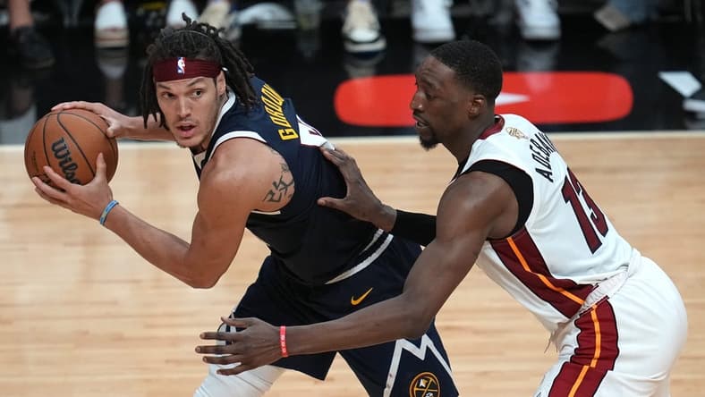 Jun 9, 2023; Miami, Florida, USA; Denver Nuggets forward Aaron Gordon (50) controls the ball while defended by Miami Heat center Bam Adebayo (13) during the second half in game four of the 2023 NBA Finals at Kaseya Center. Mandatory Credit: Jim Rassol-USA TODAY Sports
